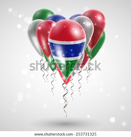 Flag of Gambia on air balls in heart-shaped. Celebration and gifts. Ribbon in the colors are twisted under the balloon. Independence Day. Balloons on the feast of the national