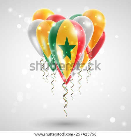 Flag of Senegal on air balls in heart-shaped. Celebration and gifts. Ribbon in the colors are twisted under the balloon. Independence Day. Balloons on feast of the national