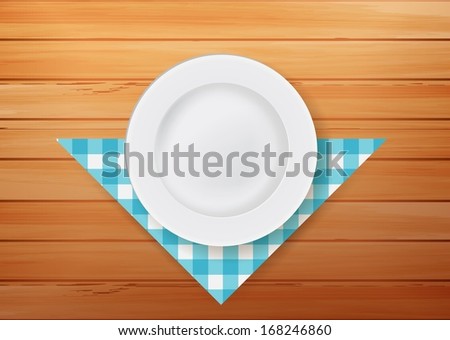 Plate with napkin on wood background