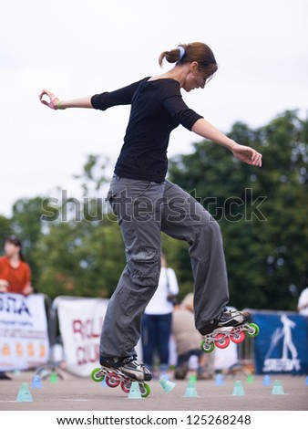 MOSCOW - JULY 21: Gorky Park, Sofia Stavinova performs a onewheel slalom element - Russian Rollerskating Federation Championship on July 21, 2012 in Moscow