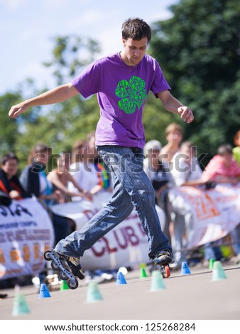 MOSCOW - JULY 21: Gorky Park, Gleb Vinogradov performs a style-slalom element - Russian Rollerskating Federation Championship on July 21, 2012 in Moscow