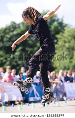 MOSCOW - JULY 21: Gorky Park, Nikita Arkhipov performs a onewheel spin slalom element - Russian Rollerskating Federation Championship on July 21, 2012 in Moscow