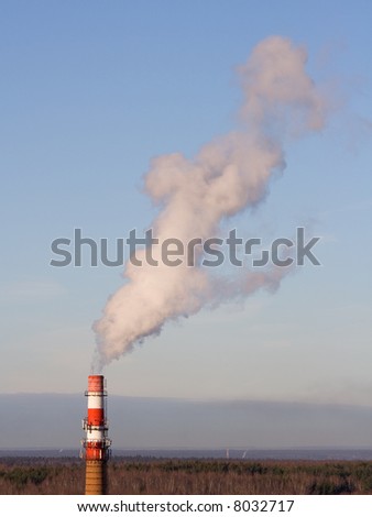 Stand-alone red-white boiler-house chimney smoking