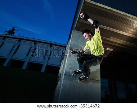 Wide angle photo of a roller performing wall-ride element - photo with a little natural motion blur