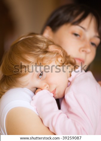 Sleepy little child with mom - shallow DOF, focus on little girl\'s eyes
