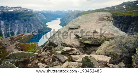 Beautiful summer vibrant view on Norwegian fjord with a house, forest, rocks, blue sky and reflection. Norway Mountain Vibrant Landscape Trolltunga Odda Fjord Norge Hiking Trail