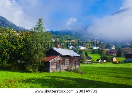 Beautiful norwegian village Roldal with scandinavian cottages, mountains and lake, summer in Norway