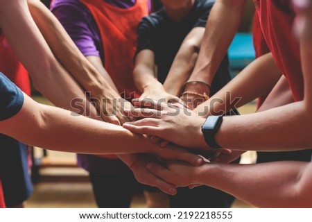 Team of kids children basketball players stacking hands in the court, sports team together holding hands getting ready for the game, playing indoor basketball, team talk with coach, close up of hands Foto stock © 