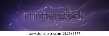 Very big lightning on the city, night cityscape with strong lightning, majestic view on night town in dark stormy night