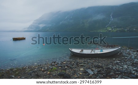 Beautiful norwegian summer landscape with mountains, boat, lake and fjord, Norway
