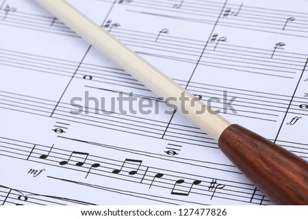 Conductor\'s baton and music score.