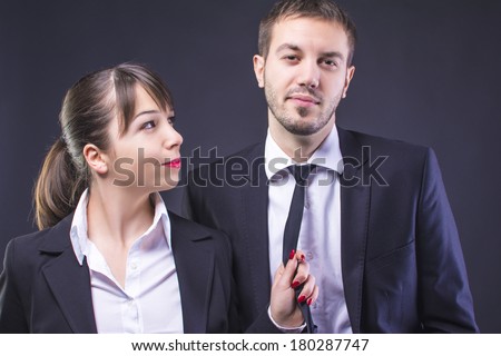 Well dressed woman holding partners necktie