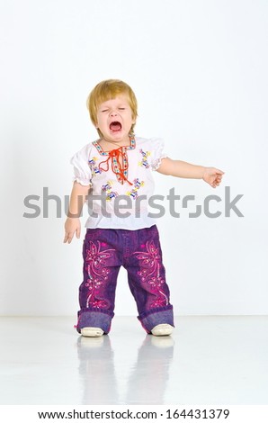 blue-eyed girl in jeans full length indoors. indignant cries. cry, open mouth