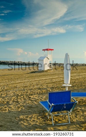 Rescue tower on the sand. place for lifeguard. Rescue tower on an empty sandy beach and one empty lounger