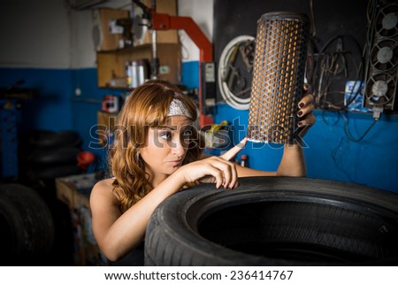auto service station, the girl in the garage keeps tire. the employee of the garage, working specialty