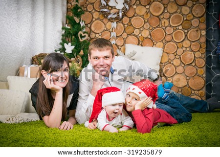 happy family with two children in waiting for the new year. Portrait of friendly family. Christmas evening