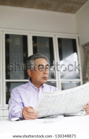 Oriental people read the newspaper