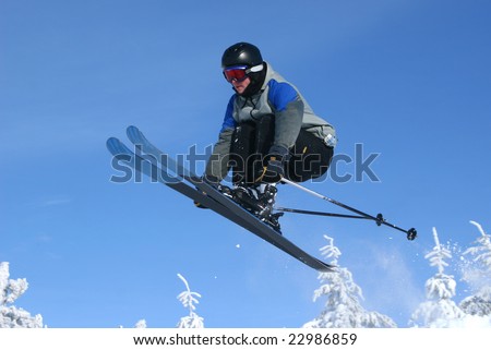 Teen ski jumping in fresh snow and sun