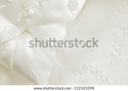 Wedding satin pillow on a white lace background