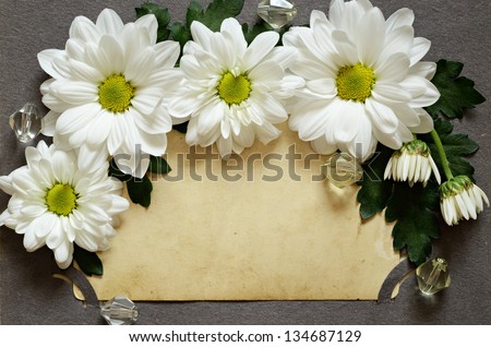 Daisies with backdrop of grunge old photo in an album