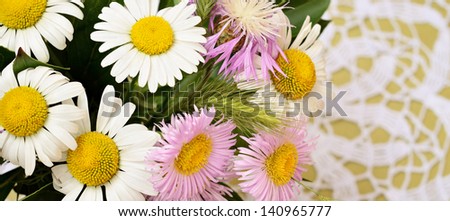 Bouquet of daisies on a crochet background