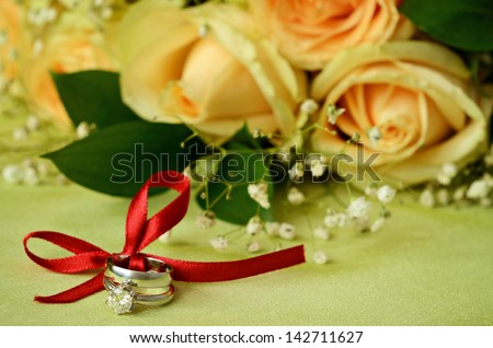 Engagement and wedding rings with flowers