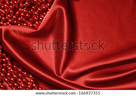 Red satin draped in the form of heart and red beads