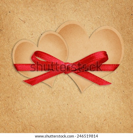 Brown craft paper hearts tied with ribbon for Valentine\'s Day