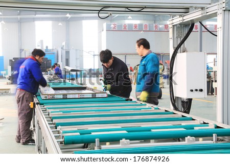 TANGSHAN - DECEMBER 22: Machinery and equipment in the workshop, in a solar equipment manufacturing enterprises on december 22, 2013, tangshan, china.