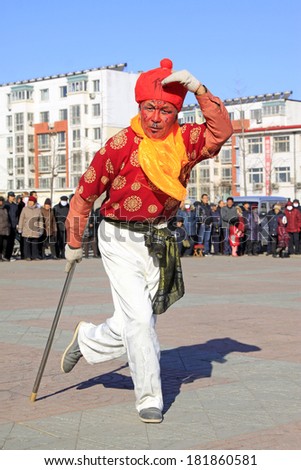 LUANNAN COUNTY - FEBRUARY 9: Monkey King wearing colorful clothes, performing yangko dance in the street, during the Chinese Lunar New Year, February 9, 2014, Luannan County, Hebei Province, China.