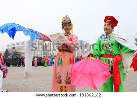 LUANNAN COUNTY - FEBRUARY 15: Performer wearing colorful clothes, performing yangko dance in the street, during the Chinese Lunar New Year, February 15, 2014, Luannan County, Hebei Province, China.
