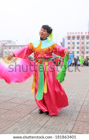 LUANNAN COUNTY - FEBRUARY 15: Performer wearing colorful clothes, performing yangko dance in the street, during the Chinese Lunar New Year, February 15, 2014, Luannan County, Hebei Province, China.
