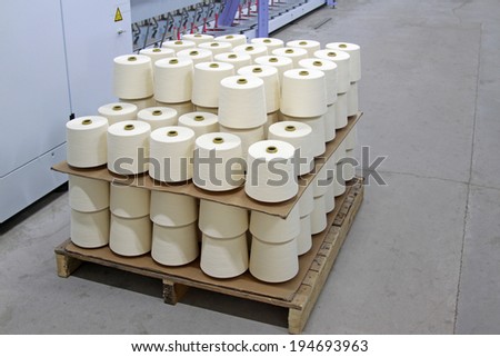 cotton yarn in spinning workshop, closeup of photo