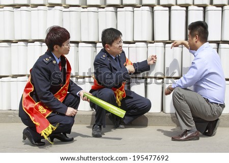 LUANNAN - MAY 4: Tax officials in ceramics factory visit, on May 4, 2014, Luannan county, hebei province, China.