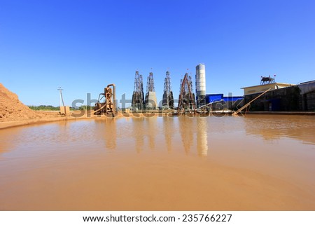 LUANNAN COUNTY - OCTOBER 13: Drilling rig derrick and yellow water in MaCheng iron mine, on october 13, 2014, Luannan County, Hebei Province, China