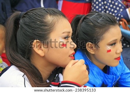LUANNAN COUNTY - SEPTEMBER 27: Red national flag on the girl\'s face at the National Day party, on september 27, 2014, Luannan County, Hebei Province, China