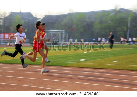 LUANNAN COUNTY - APRIL 14: 400 meter relay runner at the sports meeting, April 14, 2015, Luannan County, Hebei Province, China