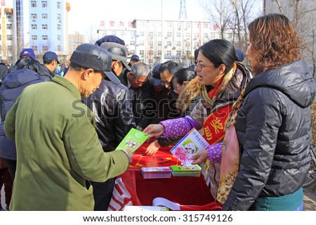 LUANNAN COUNTY - FEBRUARY 27: People get publicity materials in a social activity, on February 27, 2015, Luannan County, Hebei province, China