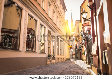 Vintage retro travel image of a narrow medieval street in old town Riga at sunset - Latvia - European capital of culture 2014
