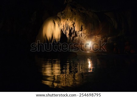 Unique image of Puerto Princesa subterranean underground river from inside - Adventurous trip in exclusive Philippines destinations - Dark lighting with the real feeling from visitor\'s point of view