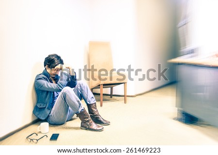 Depressed hipster business woman sitting on the floor with headache - Failure and breakdown concept and stress due to work excess - Vintage filtered look with soft focus and slightly defocused edges