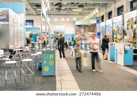 BERLIN, GERMANY - MARCH 8, 2014: attendees and expositors in Ukraine area at ITB Travel Trade Show in the fairgrounds of Messe Berlin. Blurred motion on people due to long exposure.