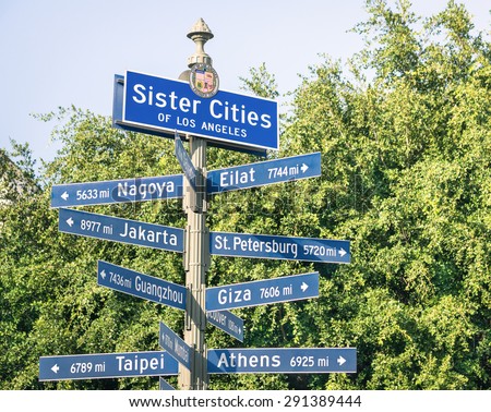 Modern street sign of Sister Cities of Los Angeles - Urban concept and road traffic directions in California - Twinning concept with world famous capital destinations - Soft vintage filtered look
