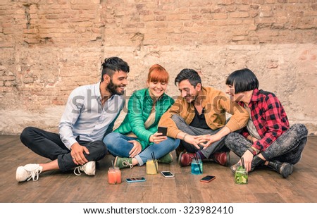 Group of hipster best friends with smartphones in grungy alternative location - Young entrepreneurs people resting at cocktail bar renovation - Friendship fun concept with trend technology interaction