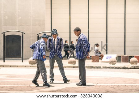 JOHANNESBURG, SOUTH AFRICA - NOVEMBER 13, 2014: young students at Gandhi square. After renovation finished in 2002, the area got a renovated bus terminal , 24-hour security.