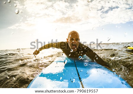 Image, Stock Photo Man swimming on surfboard in sea