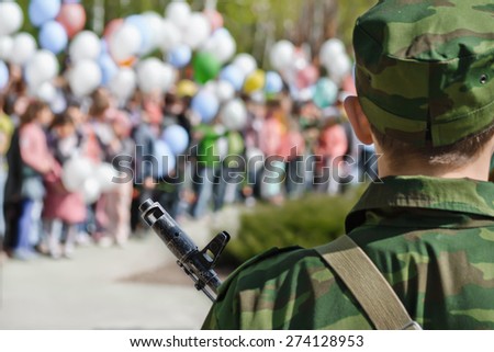 KOLTSOVO, RUSSIA: MAY 9, 2014 - Backside shot of man in military uniform standing with rifle