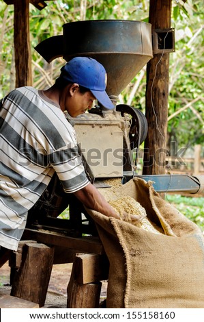 SALAVAN, LAO PDR - FEBRUARY 21: Unidentified coffee farmer is using coffee hulling machine in his coffee farm at Vangyawn village, February 21, 2013, Lao Ngam,Salavan, Lao PDR.