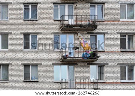 ST. PETERSBURG, RUSSIA - MARCH 10: surfboard and car tires on the balcony of an apartment building  in St. Petersburg, Russia, 10 march, 2015