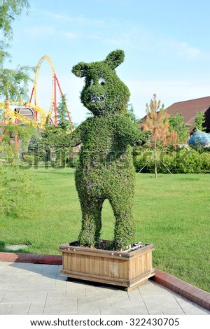 SOCHI, RUSSIA - JUNE 28, 2015: figure of a bear out of the bushes in popular Russian theme Park 